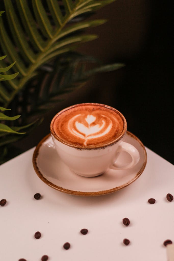 A cup of coffee with a latte art on it